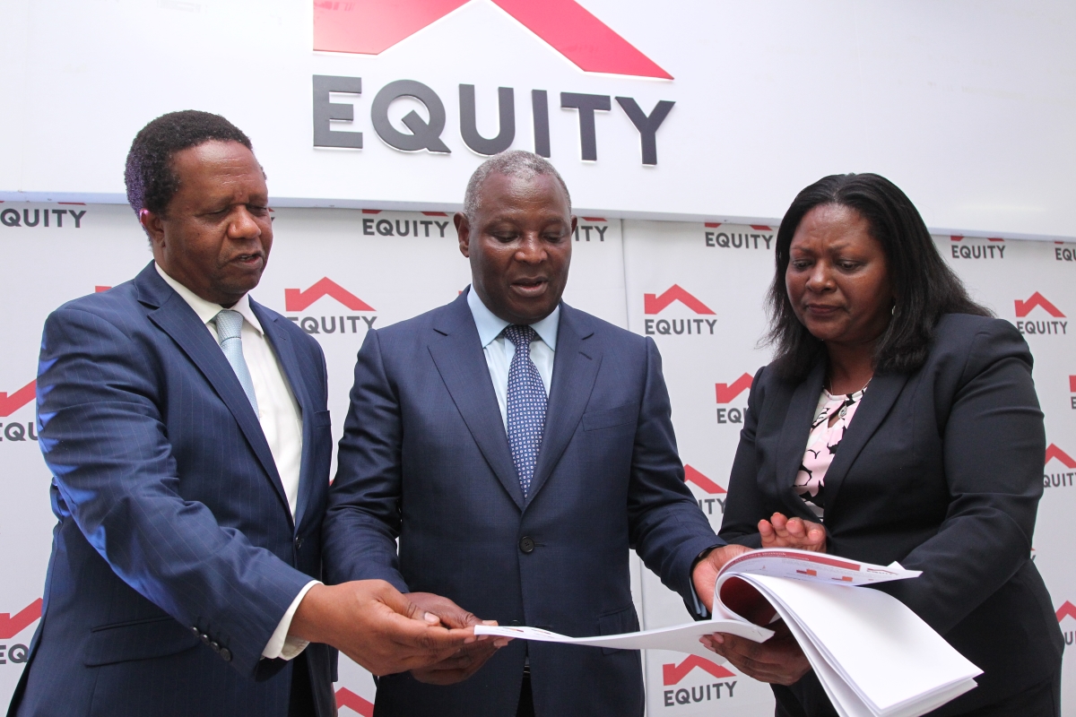 Dr. James Mwangi, Equity Group Managing Director and CEO (centre) engages with Sam Gitwekere, Group Director Enterprise Risk (left) and Mary Wamae, Group Executive Director (right) engage during the 2022 quarter one investor briefing and release of financial results.